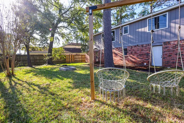 a backyard of a house with barbeque oven fire pit and chairs