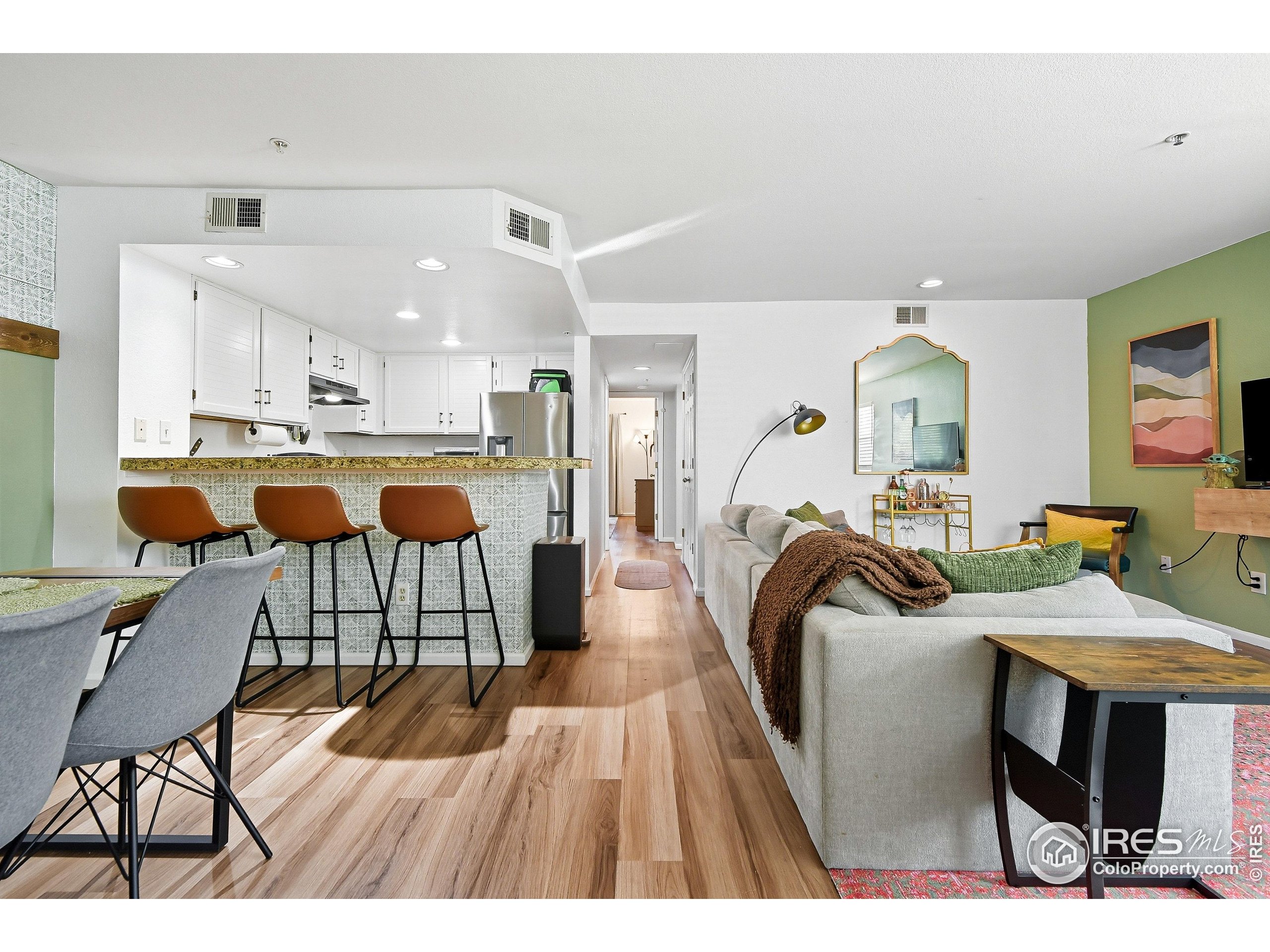 935 Broadway, Unit 104 Boulder, CO 80302 - Photo 1 of 21 a view of a dining room with furniture and wooden floor