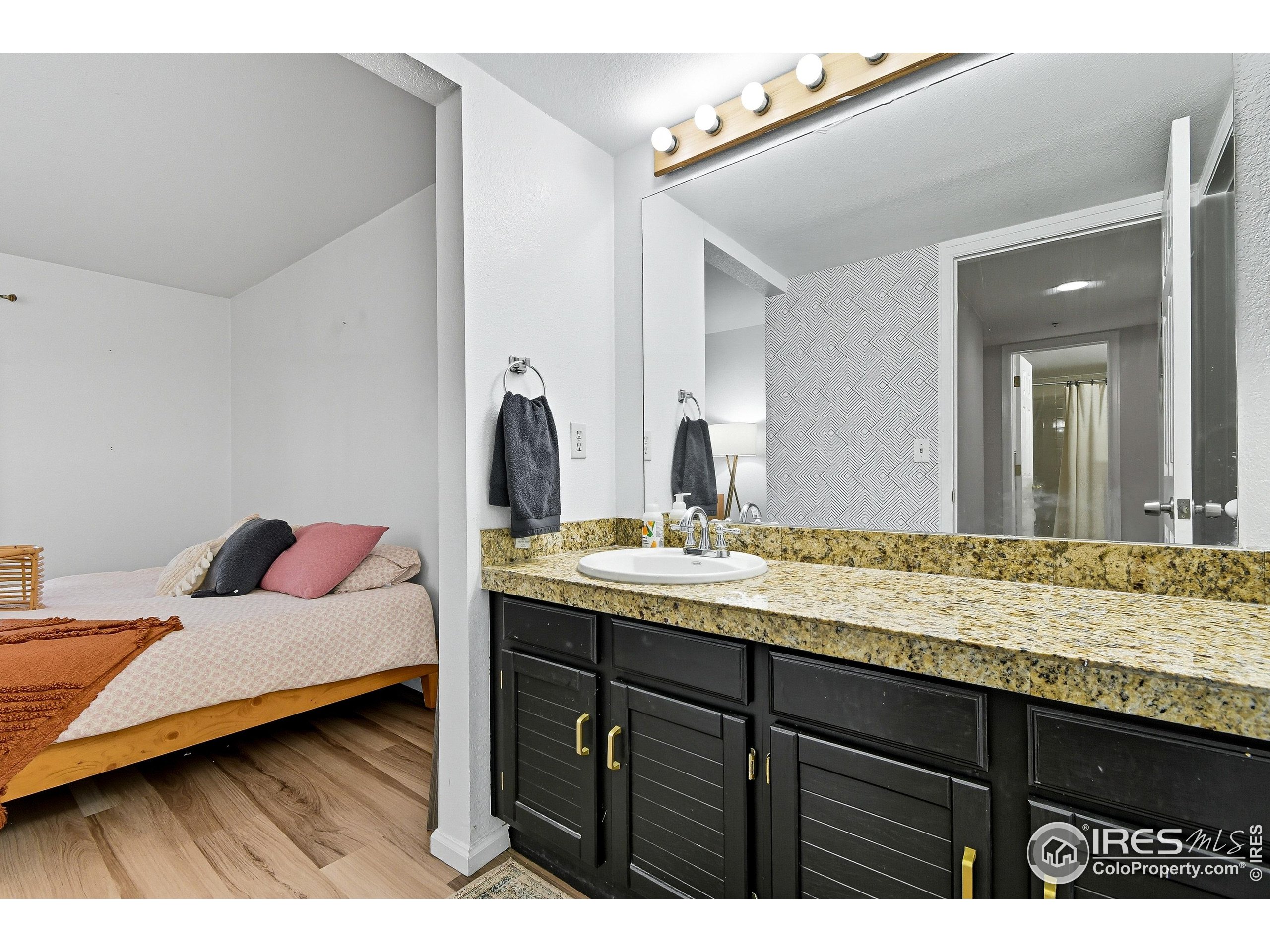 935 Broadway, Unit 104 Boulder, CO 80302 - Photo 12 of 21 a en suite bathroom with a sink and mirror