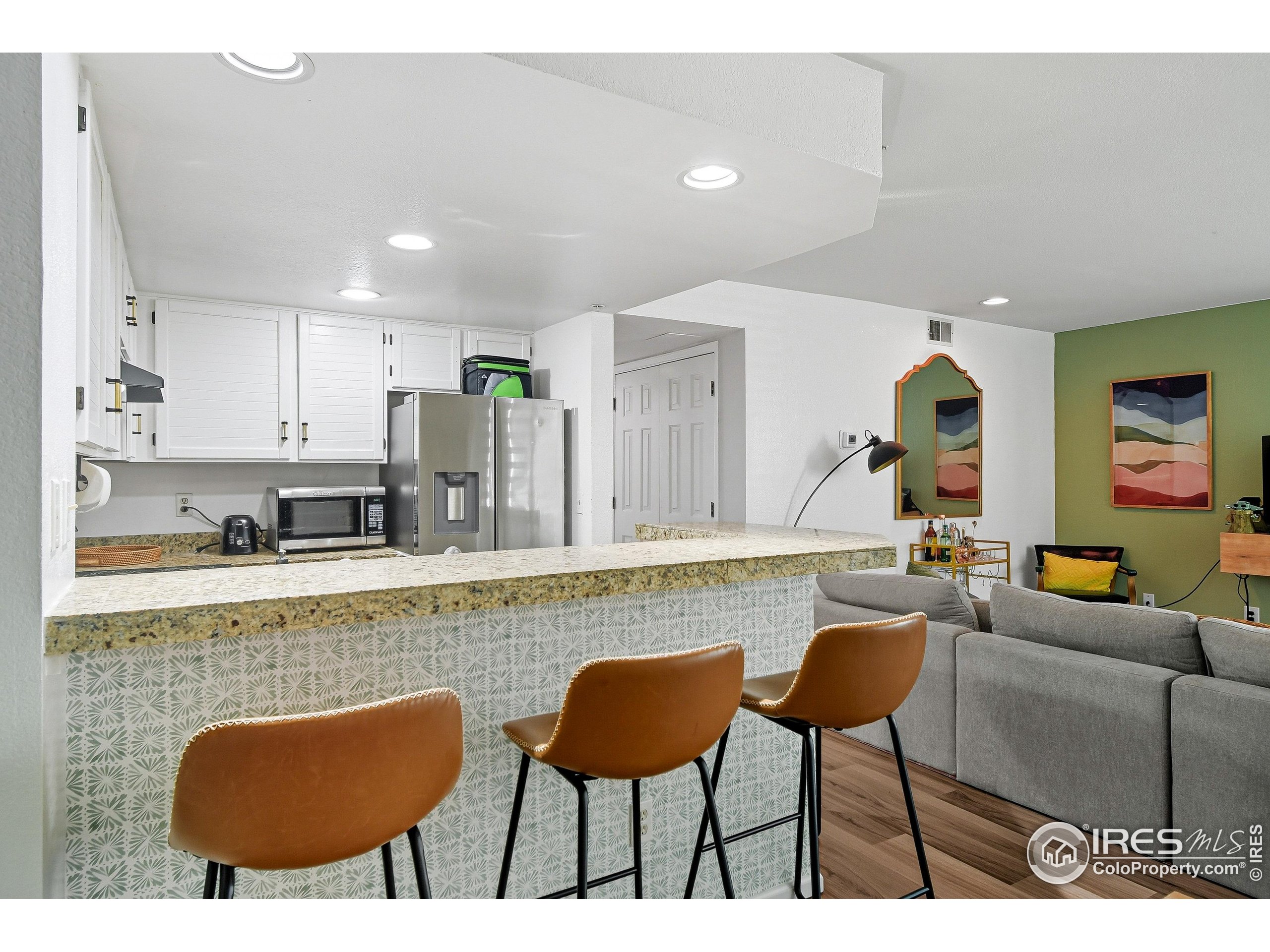 935 Broadway, Unit 104 Boulder, CO 80302 - Photo 20 of 21 a living room with furniture a rug and kitchen view