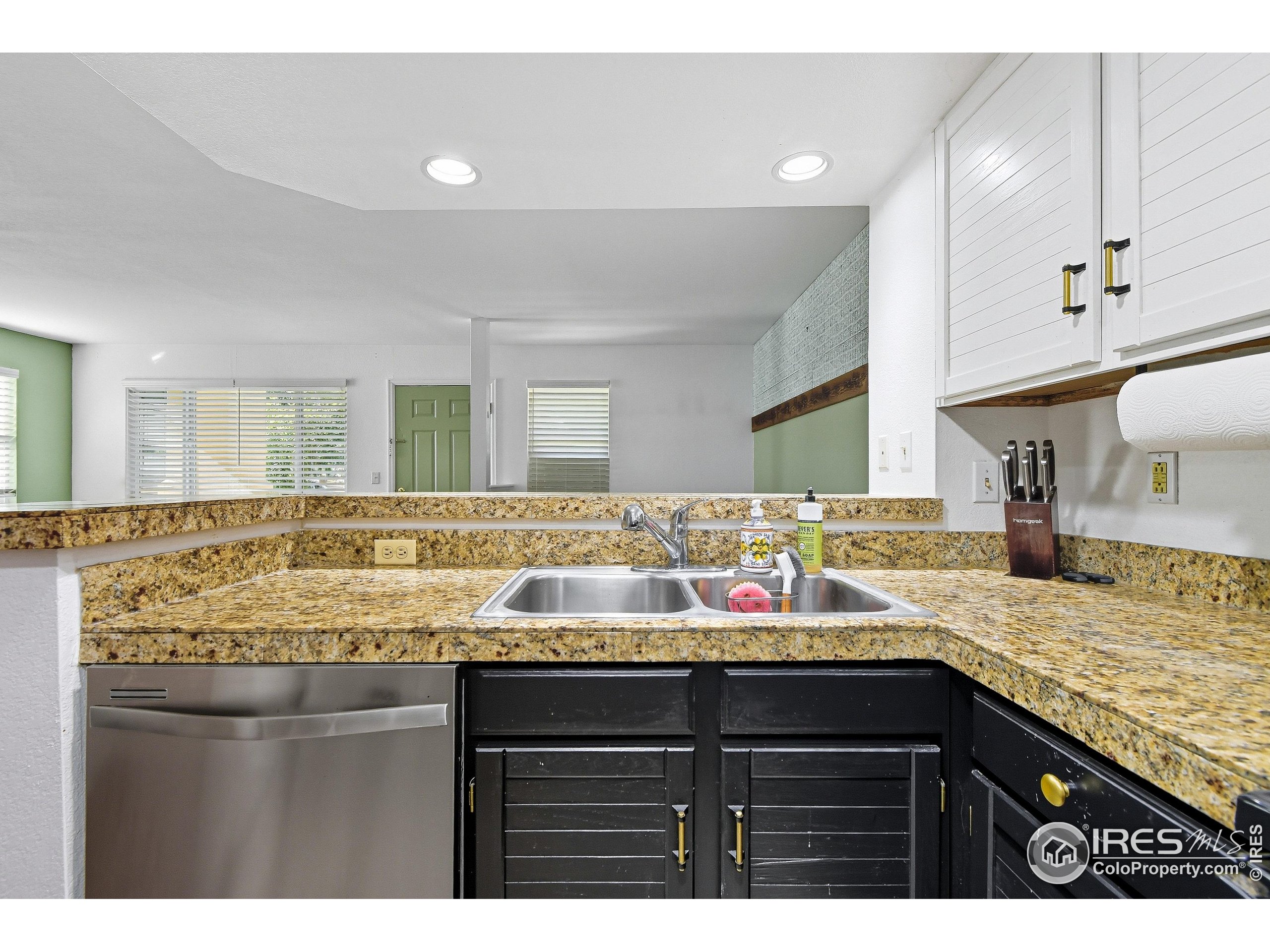 935 Broadway, Unit 104 Boulder, CO 80302 - Photo 21 of 21 a bathroom with a granite countertop sink and a mirror