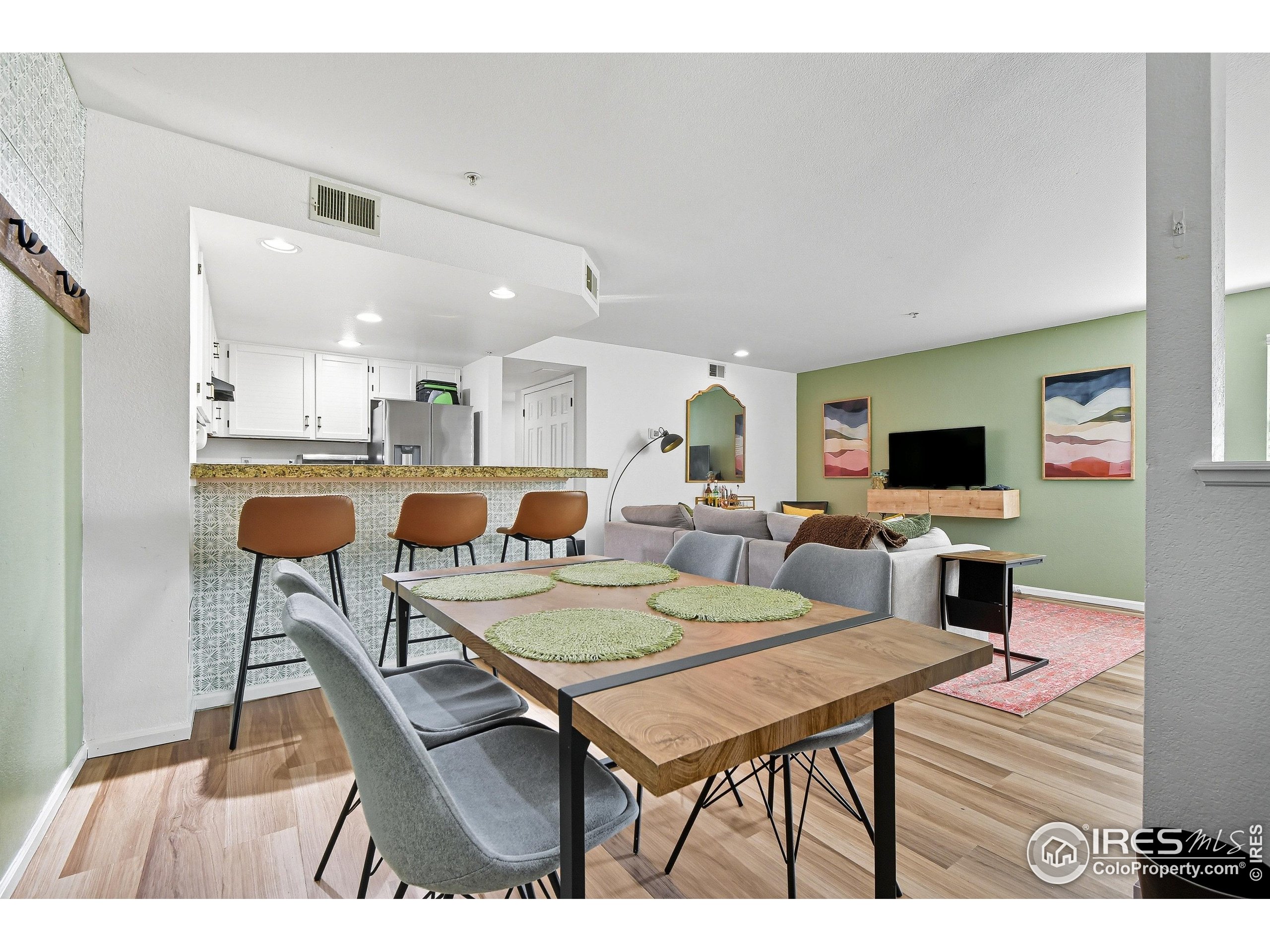 935 Broadway, Unit 104 Boulder, CO 80302 - Photo 6 of 21 a living room with furniture a flat screen tv and a table