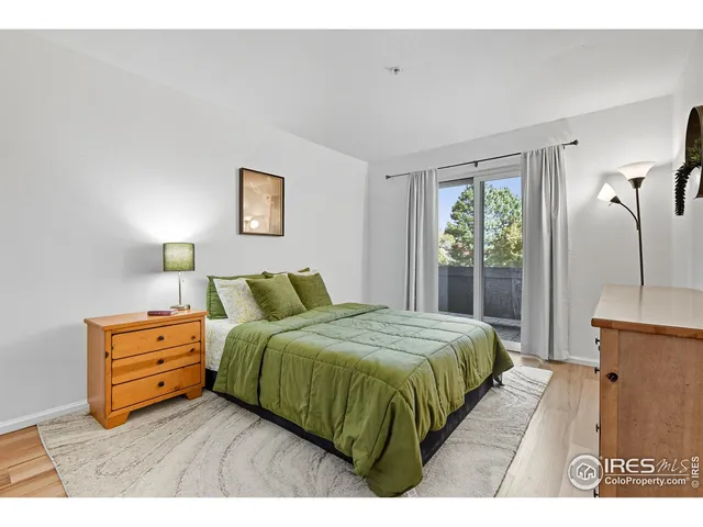 a bedroom with a bed and a night stand