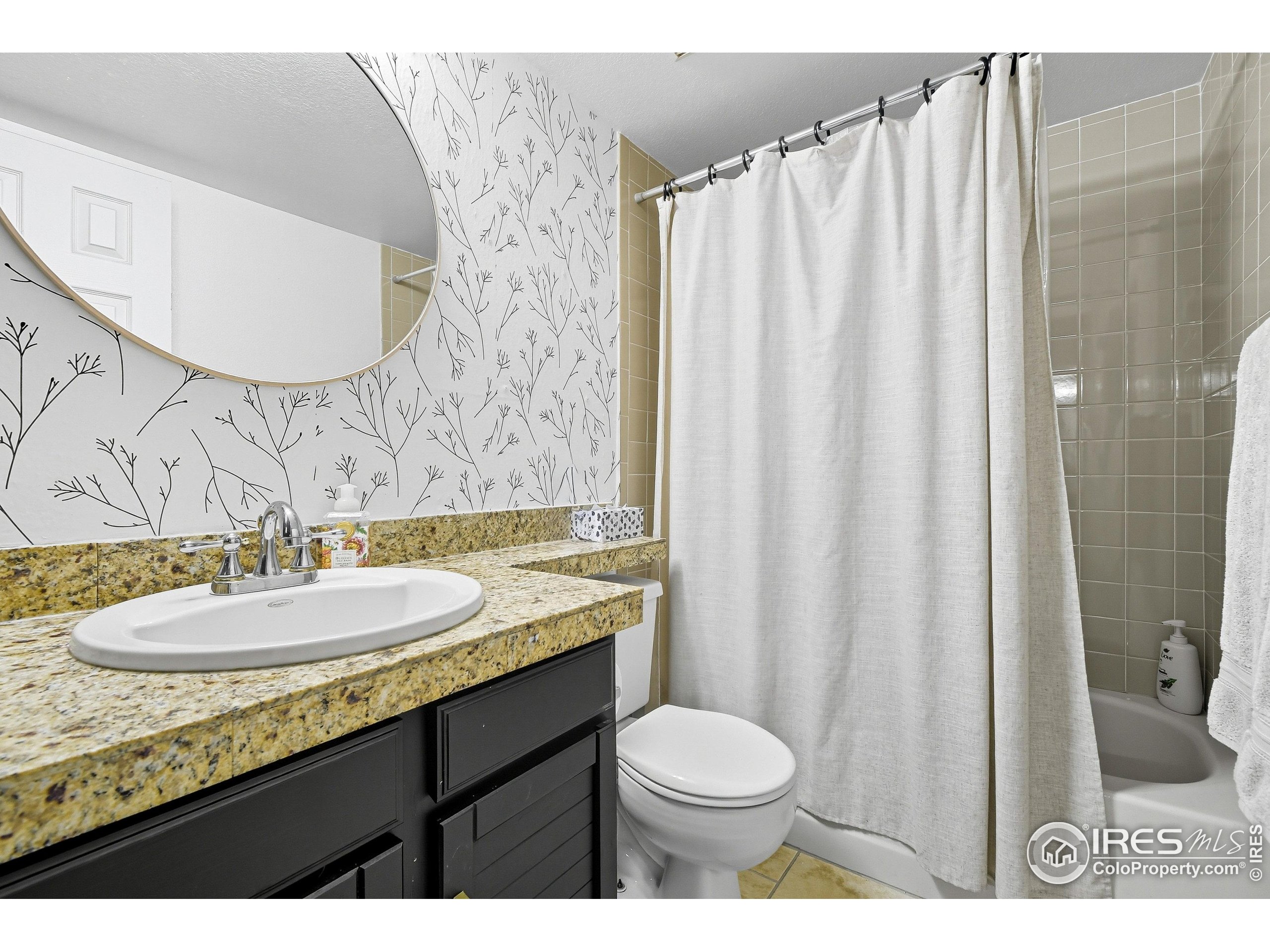 935 Broadway, Unit 104 Boulder, CO 80302 - Photo 10 of 21 a bathroom with a granite countertop sink and a mirror