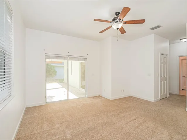 a view of a livingroom with a ceiling fan and window