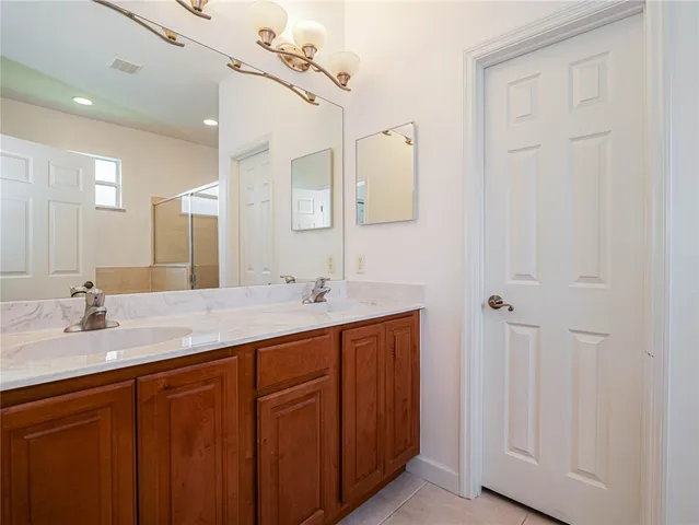 a bathroom with a double vanity sink and a mirror