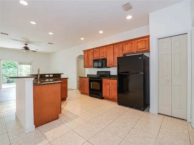 a kitchen with stainless steel appliances granite countertop a refrigerator and a stove