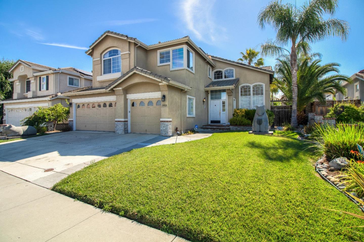 9402 Rodeo Drive Gilroy, CA 95020 - Photo 2 of 39 a front view of a house with yard and green space