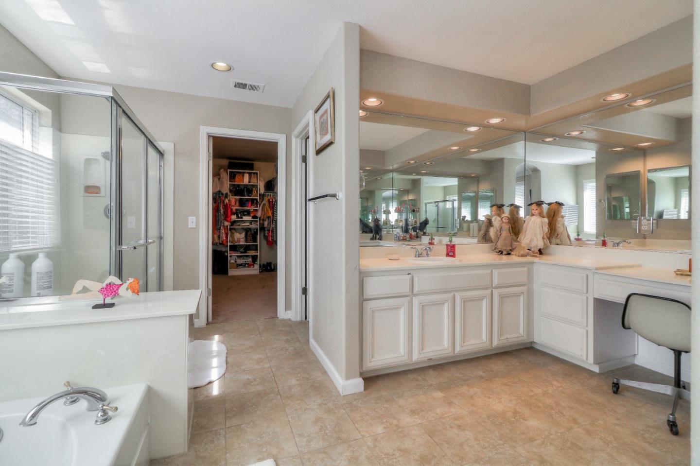 9402 Rodeo Drive Gilroy, CA 95020 - Photo 27 of 39 a bathroom with a sink vanity and a mirror