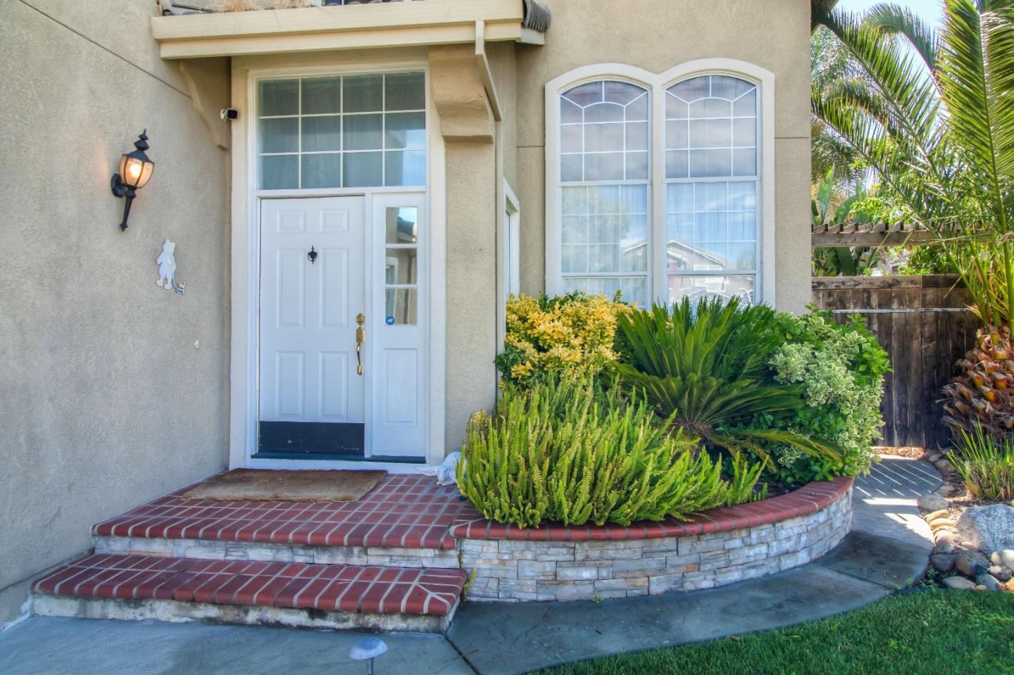 9402 Rodeo Drive Gilroy, CA 95020 - Photo 3 of 39 a front view of a house with a garden