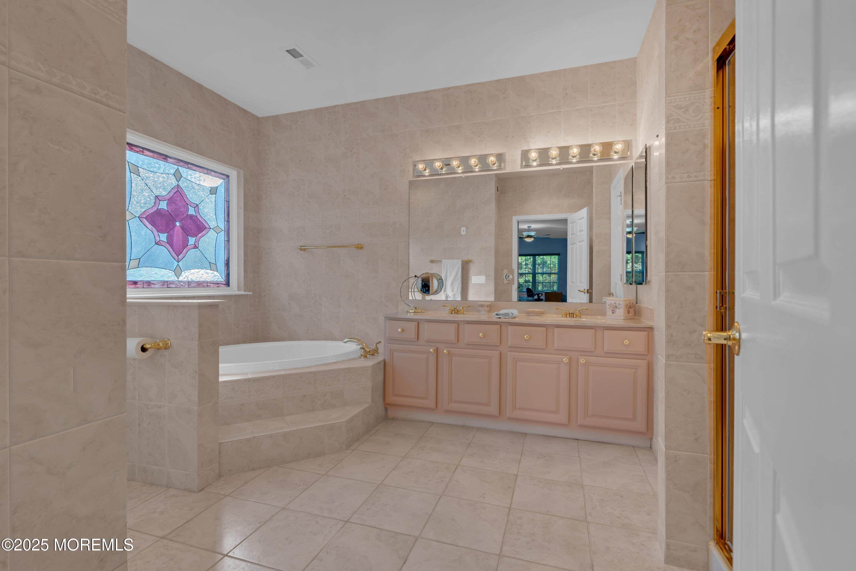 60 Eleanor Road Manchester Township, NJ 08759 - Photo 38 of 45 a spacious bathroom with a mirror a bathtub and a sink