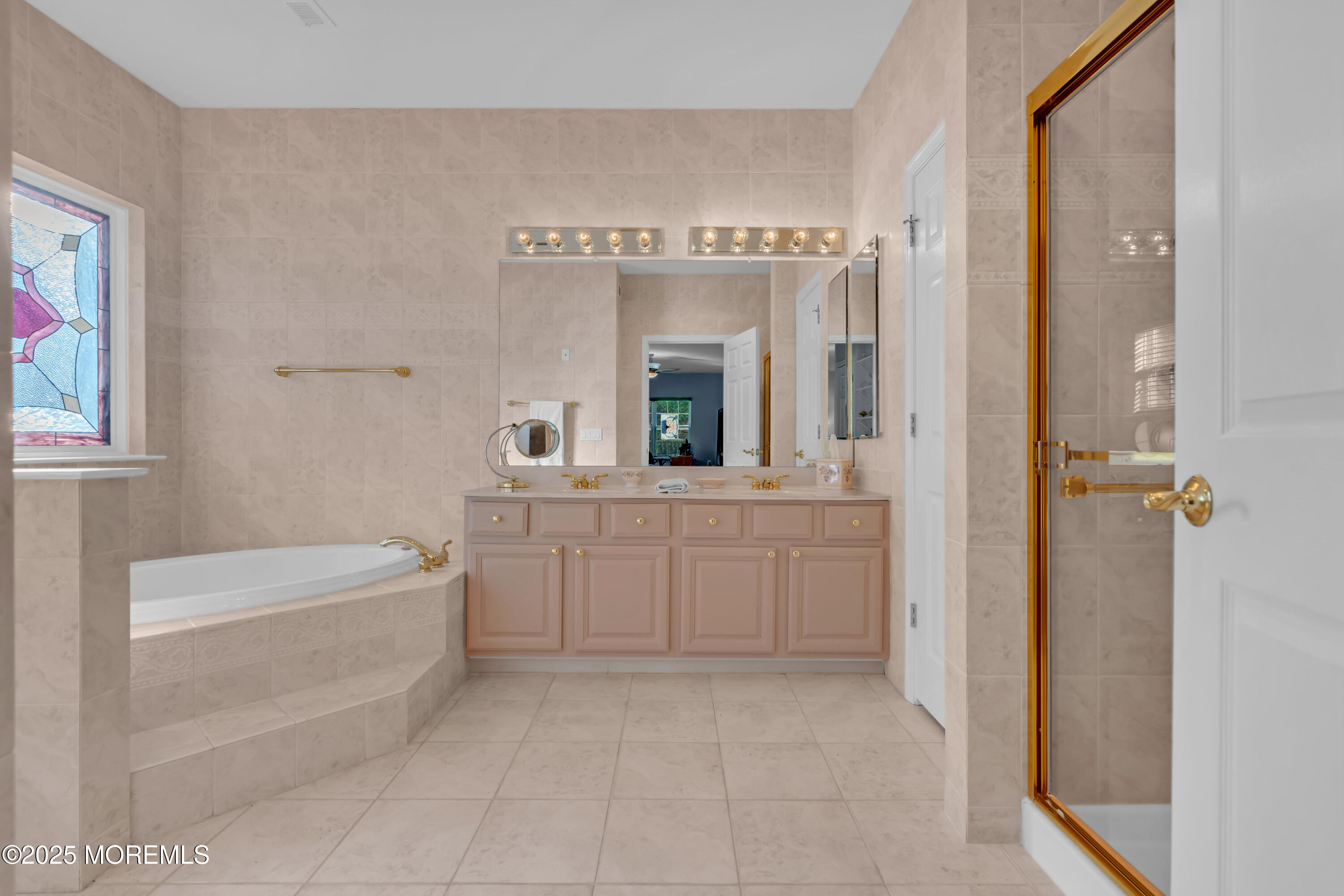 60 Eleanor Road Manchester Township, NJ 08759 - Photo 42 of 45 a spacious bathroom with a mirror a bathtub and a shower