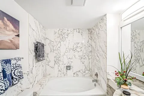 a bathroom with a bathtub and shower