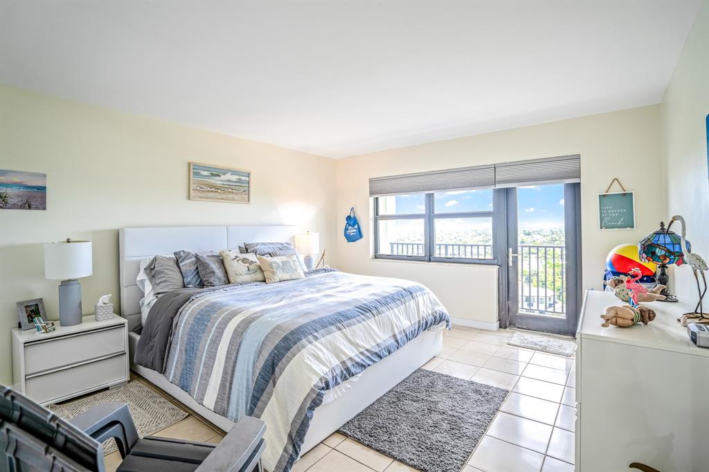 5100 North Ocean Boulevard, Unit 1217 Lauderdale-by-the-Sea, FL 33308 - Photo 16 of 32 a bedroom with a bed and a window