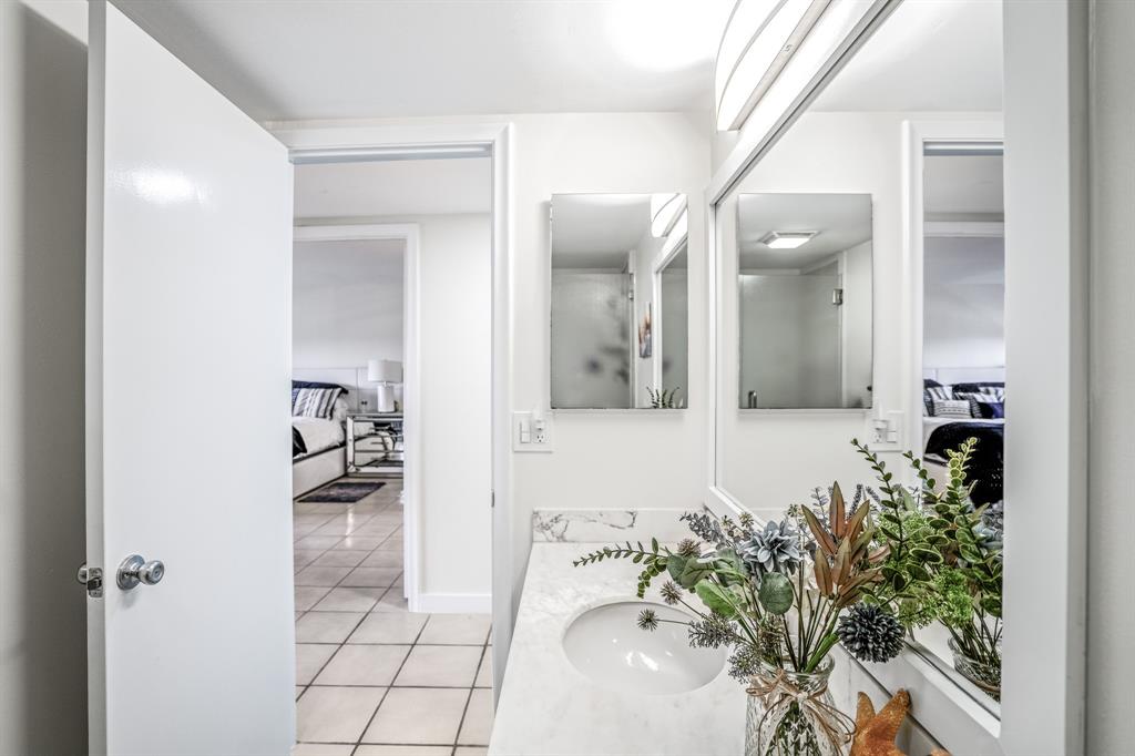 5100 North Ocean Boulevard, Unit 1217 Lauderdale-by-the-Sea, FL 33308 - Photo 19 of 32 a bathroom with a sink and mirror