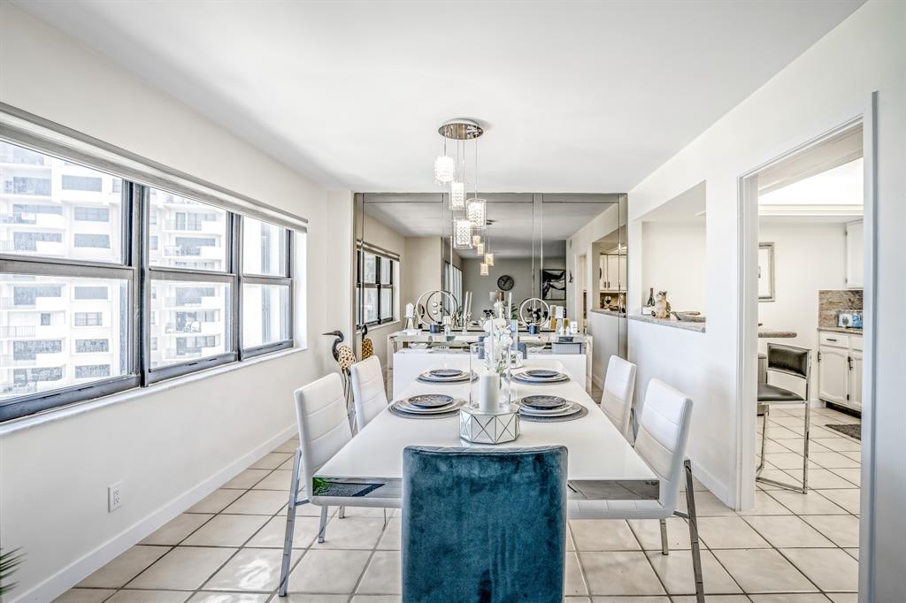 5100 North Ocean Boulevard, Unit 1217 Lauderdale-by-the-Sea, FL 33308 - Photo 2 of 32 a view of a dining room with furniture and chandelier