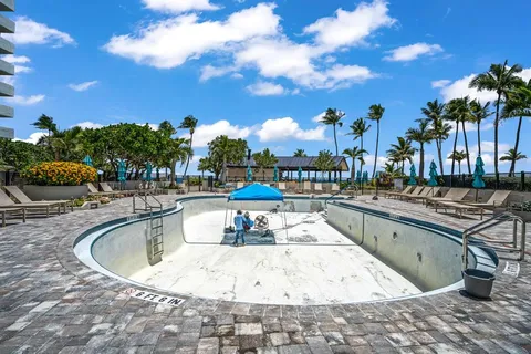 a view of a swimming pool with outdoor seating