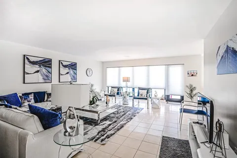 a living room with furniture or couch and a dining table with kitchen view