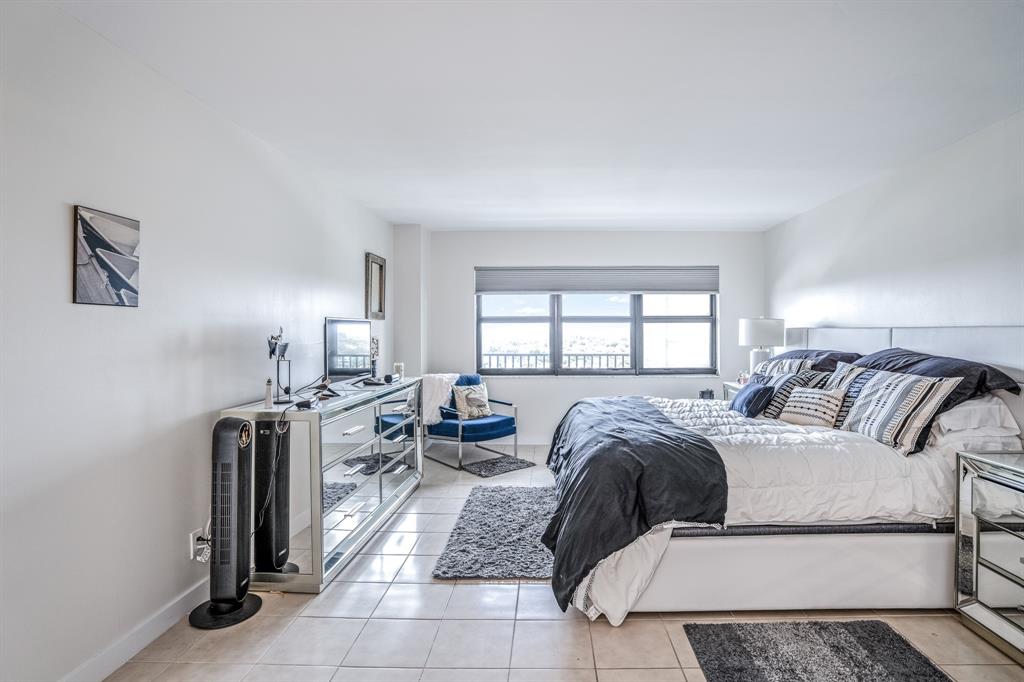 5100 North Ocean Boulevard, Unit 1217 Lauderdale-by-the-Sea, FL 33308 - Photo 9 of 32 a bed room with a bed and a couch