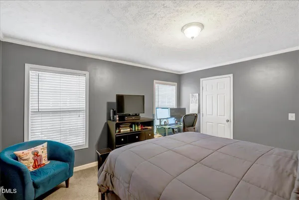 a bedroom with a bed and a television