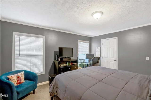 a bedroom with a bed and a television