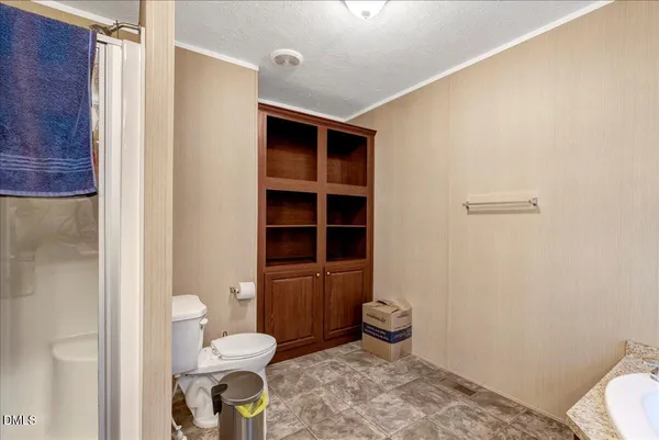 a bathroom with a toilet and a shower