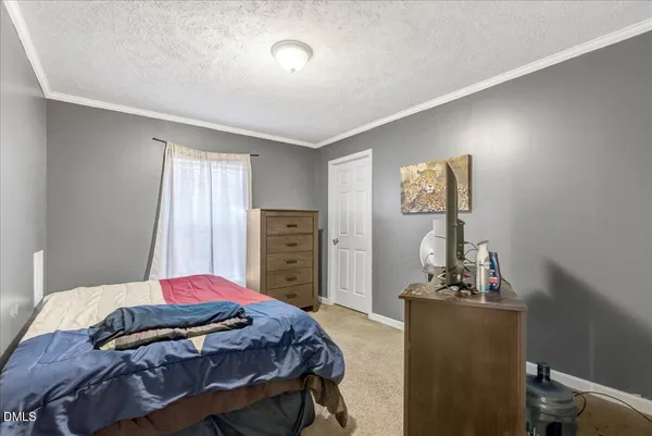 a bedroom with a bed and a dresser