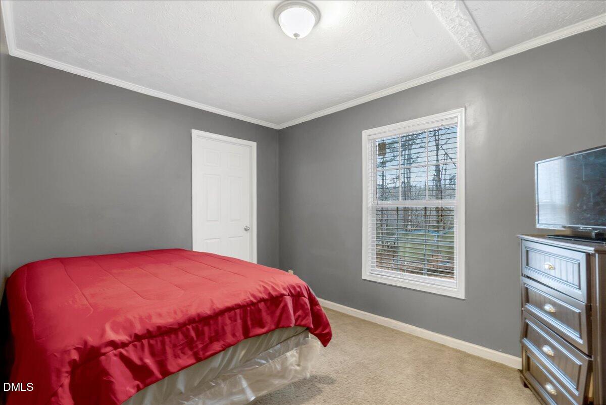 1779 Wise-Five Forks Road Macon, NC 27551 - Photo 19 of 23 a bedroom with a bed and a window