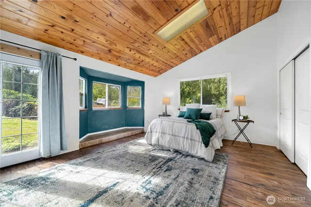 a spacious bedroom with a large bed and a chandelier