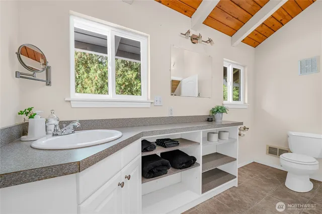 a dining room with a sink and a mirror