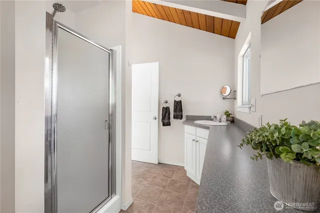 a kitchen with white cabinets and wooden floor