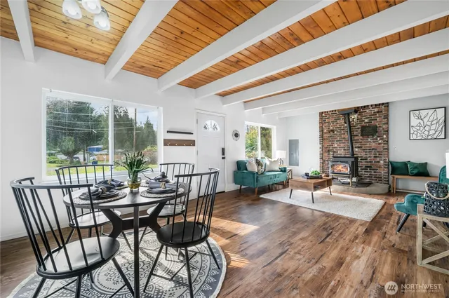 a dining room with furniture wooden floor and a chandelier
