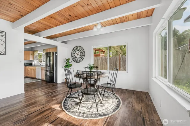 a view of a dining room with furniture window and wooden floor