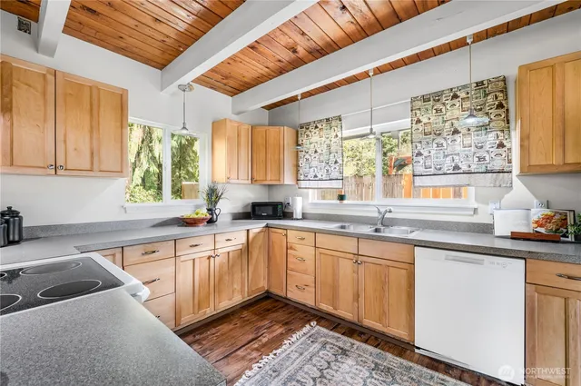 a kitchen with a sink stove and cabinets
