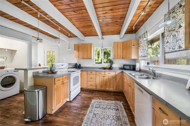 a kitchen with a sink window and cabinets