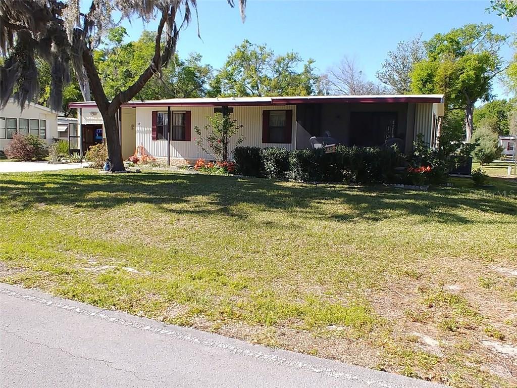 72 Robin Road Wildwood, FL 34785 - Photo 1 of 1 Beautiful front yard with screen porch facing golf course