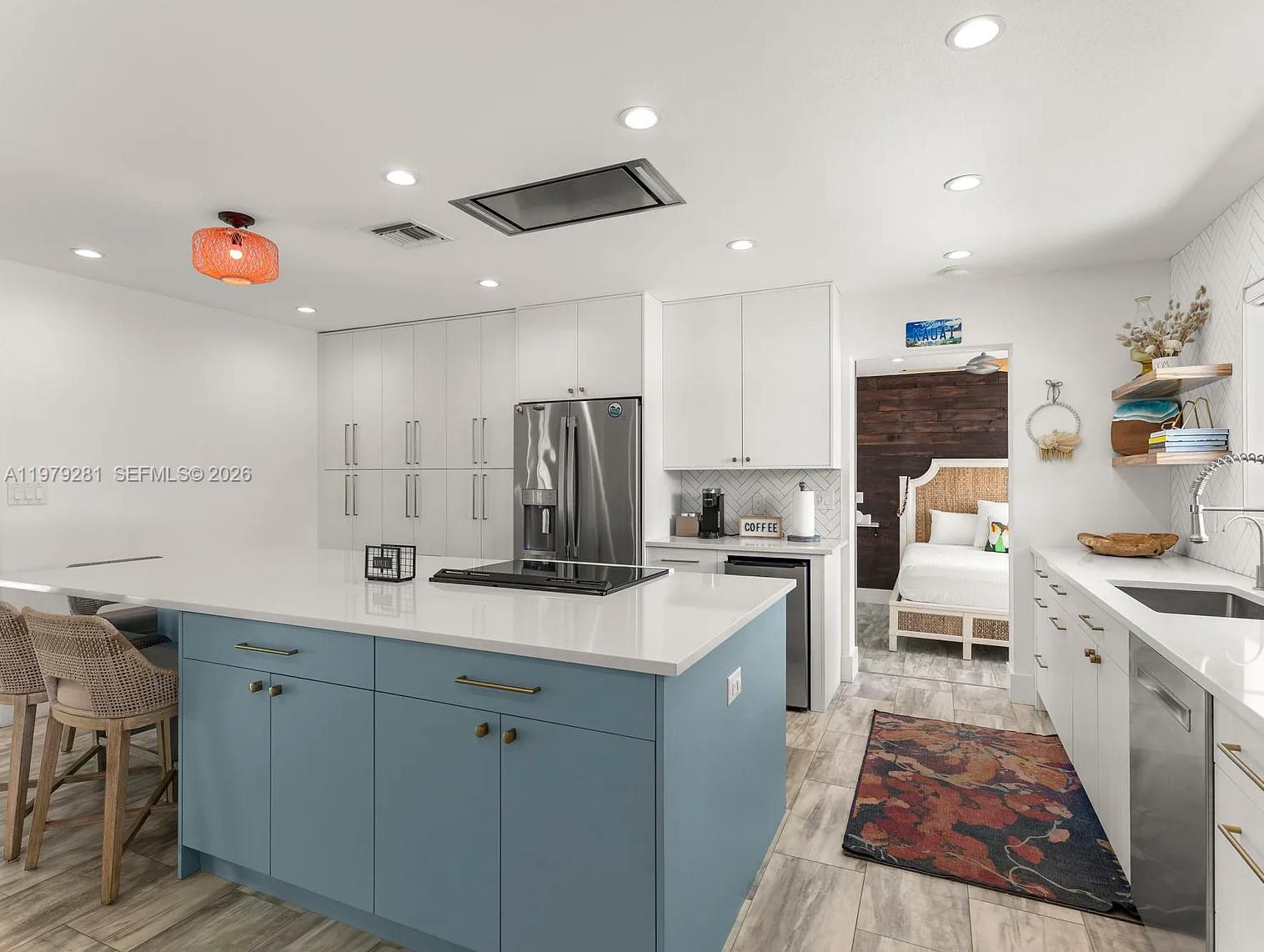 2211 Northeast 35th Court Lighthouse Point, FL 33064 - Photo 12 of 21 a kitchen with white cabinets and sink