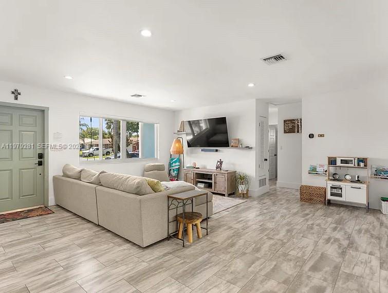 2211 Northeast 35th Court Lighthouse Point, FL 33064 - Photo 13 of 21 a living room with furniture and a flat screen tv