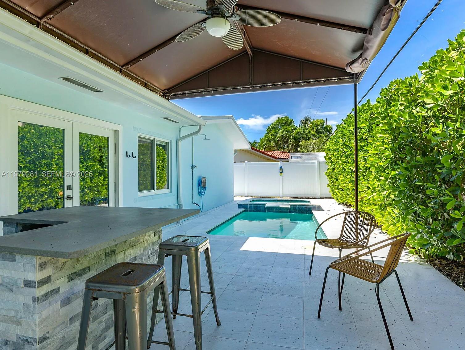 2211 Northeast 35th Court Lighthouse Point, FL 33064 - Photo 16 of 21 a view of backyard with a patio and plants
