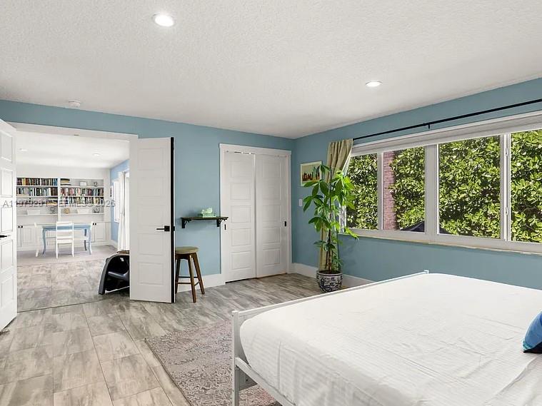 2211 Northeast 35th Court Lighthouse Point, FL 33064 - Photo 19 of 21 a bedroom with a bed and a large window