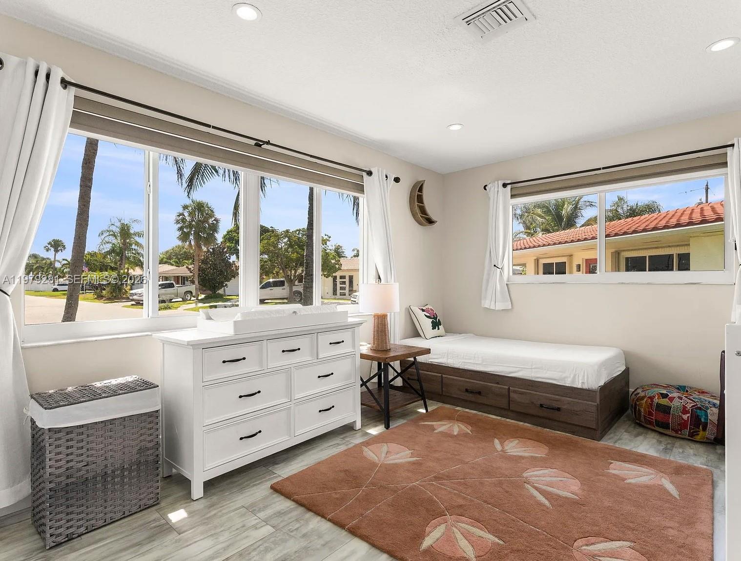 2211 Northeast 35th Court Lighthouse Point, FL 33064 - Photo 20 of 21 a bedroom with furniture and a large window