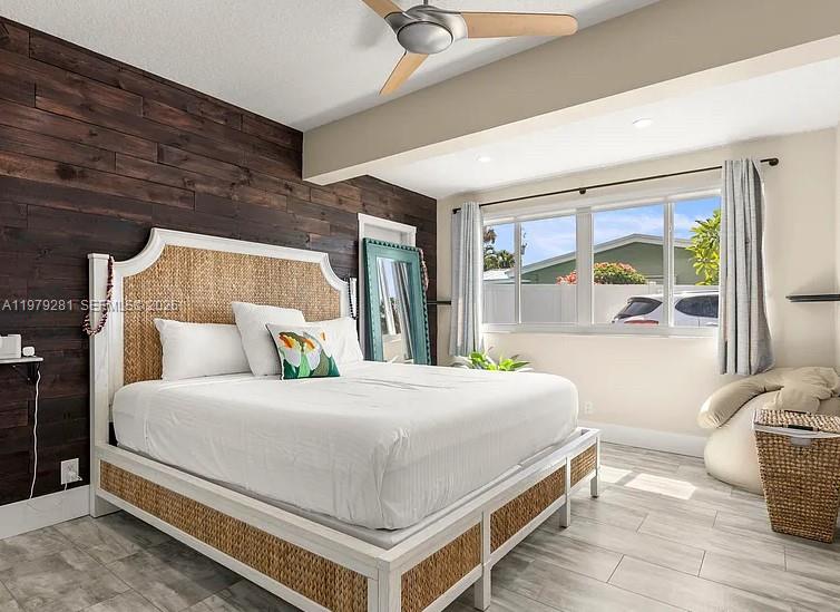 2211 Northeast 35th Court Lighthouse Point, FL 33064 - Photo 2 of 21 a bedroom with a large bed and a large window