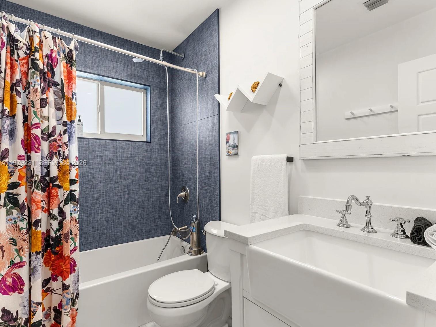 2211 Northeast 35th Court Lighthouse Point, FL 33064 - Photo 6 of 21 a bathroom with a sink a toilet and shower