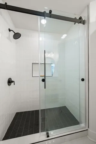 a bathroom with a glass shower door