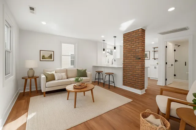 a living room with furniture and wooden floor