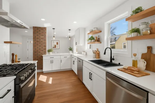 a kitchen with a stove sink and cabinets