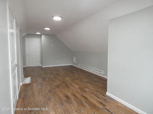 an empty room with wooden floor