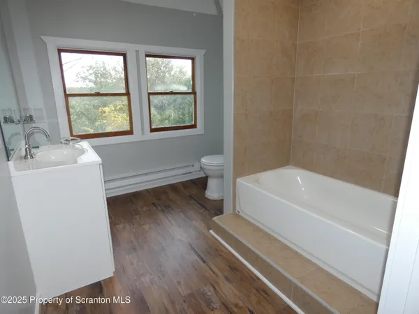 a bathroom with a toilet and a bathtub