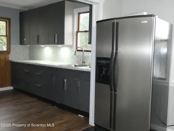 a kitchen with kitchen island a sink window and cabinets