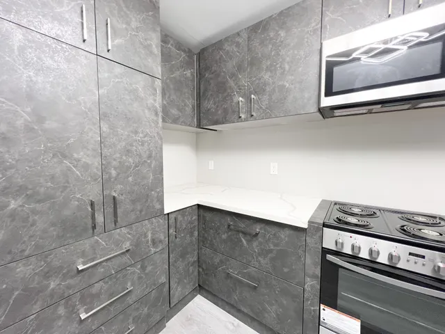 a kitchen with a stove and a microwave